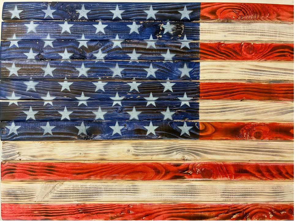 Wood American flag with a torch-burned, weathered finish that looks like reclaimed barnwood