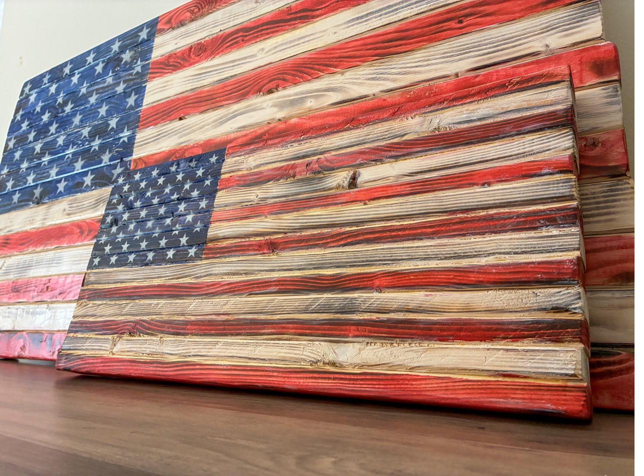 Close-up of a handcrafted wood American flag showing the raised stripe dimensions and proportions