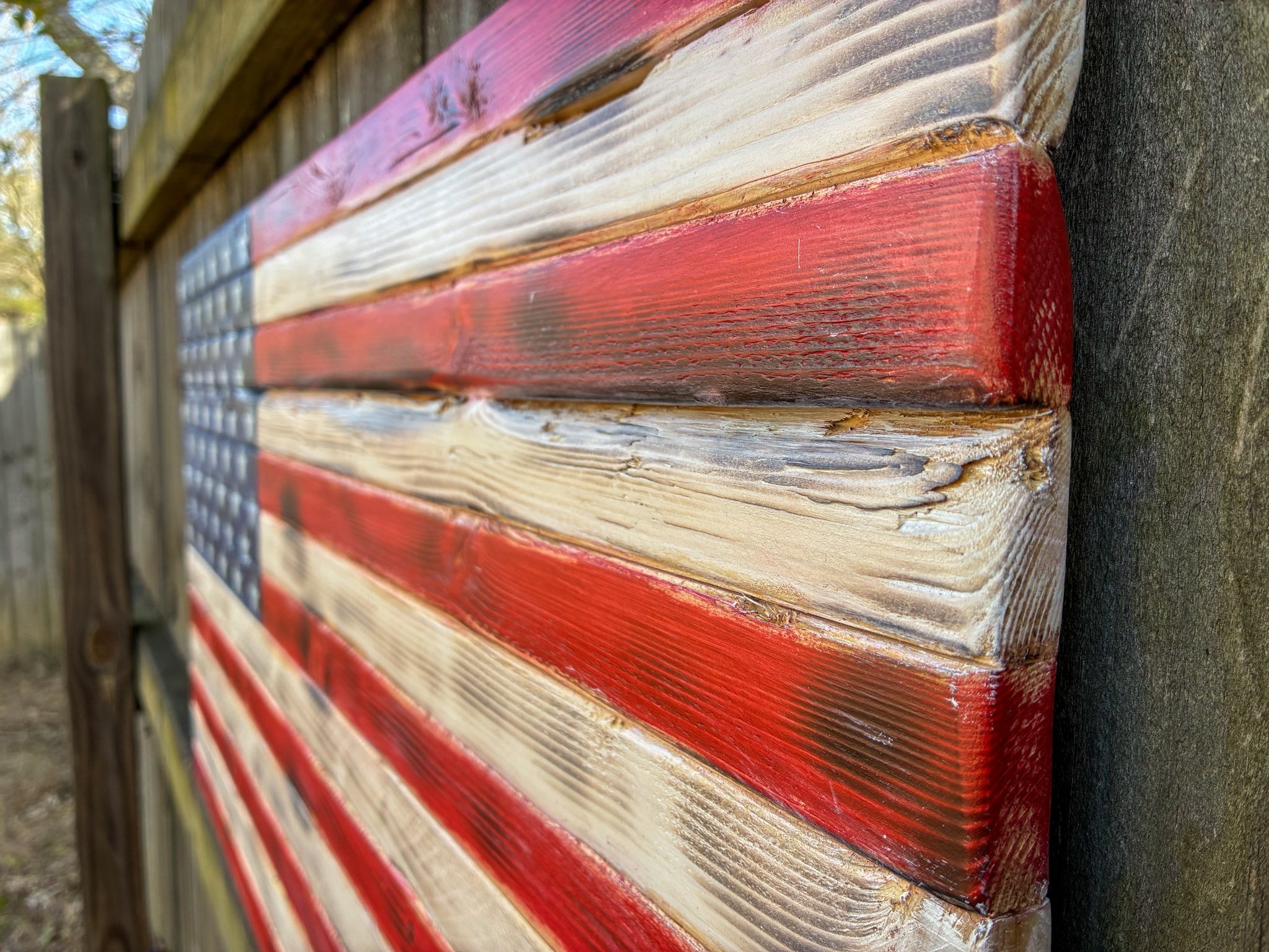 Rustic wood American flag photographed outdoors, a handmade military retirement gift